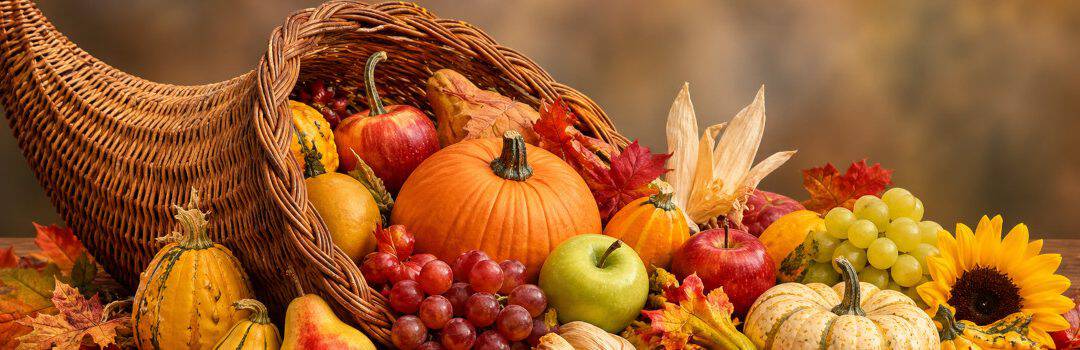 Vibrant autumn harvest with pumpkins, apples, grapes, and gourds arranged for Thanksgiving celebration. Perfect for sharing gratitude and seasonal festivities.