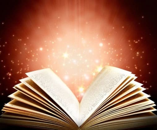 Open book with glowing light and sparkles, symbolizing inspiration and knowledge, reflecting creative storytelling and impactful messaging.