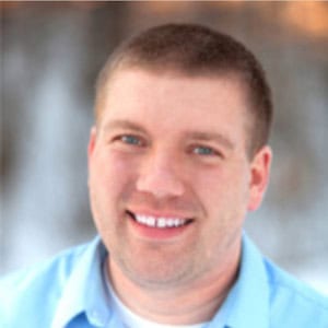 Professional man smiling outdoors, representing Difference Makers Media and digital marketing expertise.