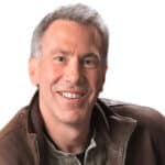 Smiling middle-aged man giving a testimonial, representing client satisfaction with Difference Makers Media services.