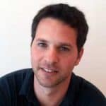 A professional headshot of a smiling man representing Difference Makers Media, showcasing client success stories and positive testimonials.