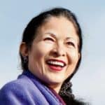 Smiling woman sharing a positive testimonial, representing client satisfaction with Difference Makers Media services.